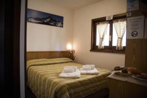 Postel nebo postele na pokoji v ubytování Hotel Marguareis