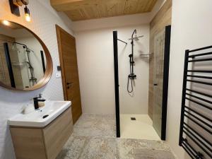 a bathroom with a sink and a shower and a mirror at Vila Snezienka in Stará Lesná +41 photos