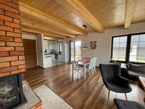 a living room and dining room with a brick wall at Vila Snezienka in Stará Lesná