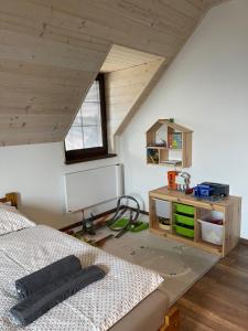a attic room with a bed and a desk at Vila Snezienka in Stará Lesná