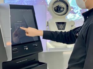 a man points to a humanoid robot with his finger at Henn na Hotel Seoul Myeongdong in Seoul