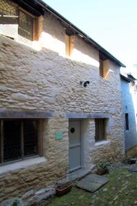 an old stone house with a door and windows at The Merchant's House in Penryn