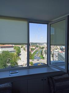 a room with two windows with a view of a city at Top Center Nice View Studio in Gabrovo