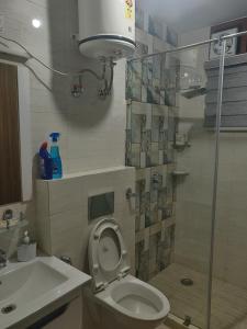 a bathroom with a shower and a toilet and a sink at Nature, Meditation with fun and Luv in Woods BAROG near KASAULI in Barog +17 photos