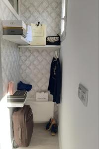a room with a shelf with luggage and bags at LA SUITE DEL CONDE LUXURY SUITES in Seville