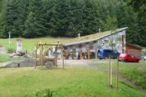 a playground in a field in front of a building at Gaestehaeuser Am Nibelungensteig in Lautertal