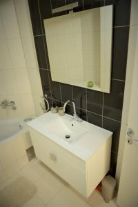 a bathroom with a white sink and a mirror at Centar in Bijeljina