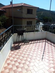 un balcone di una casa con un grill di Casa da fonte a Lavacolhos