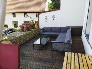 a patio with a couch and a table at Salzufler Wohntraum in Bad Salzuflen