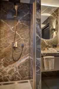 
a bathroom with a shower and a sink at Cavallaro Hotel in Haarlem
