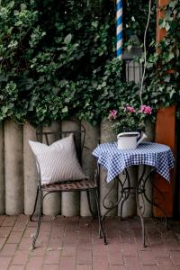 a table and a chair and a table with a plant at Hotel Vogtareuther-Hof in Vogtareuth