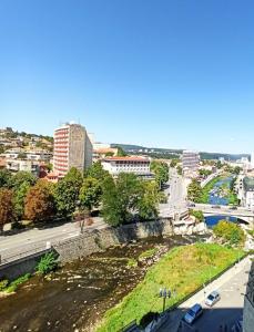 a view of a city with a river and buildings at Top center Deluxe apartment in Gabrovo