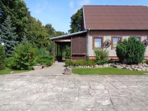 a house with a stone driveway in front of it at Sodyba Skardupiai in Vidgiriai