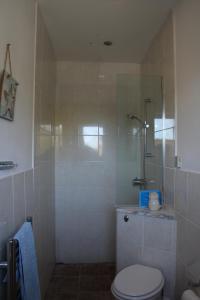 a bathroom with a shower with a toilet and a sink at Cherry Trees in Stowmarket