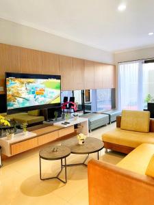 a living room with a large flat screen tv at Platinum Setrasari Guest House 5BR Private Pool Bandung in Bandung