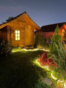 a garden with lights in front of a house at Cabañas Villa Isabel in Cajicá