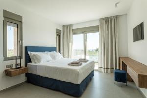 Postel nebo postele na pokoji v ubytování Manitennisvillas