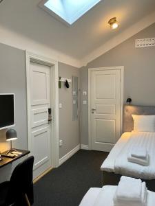 Postel nebo postele na pokoji v ubytování Unique Hotel Jungfrugatan