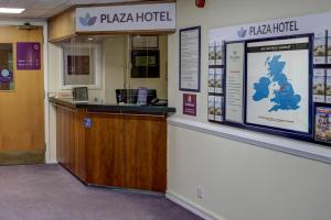 a hotel lobby with a counter and a sign at Plaza Chorley; Sure Hotel Collection by Best Western in Chorley