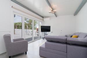 a living room with a couch and a tv at Casas Madalena in Seia