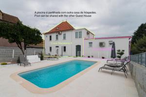 a picture of a swimming pool in front of a house at Casas Madalena in Seia