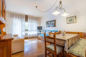 a kitchen and dining room with a table and chairs at Il Ruscello Apartment with Terrace and View of the Alps in Tarvisio