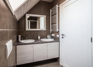 a bathroom with two sinks and a mirror at 'Virš Ąžuolų'-Forest SPA -Holiday Home in Paplatelė +38 photos