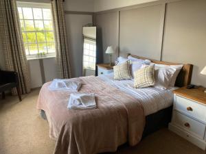 a bedroom with a large bed with two towels on it at The Ship Inn in York