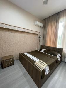 a bedroom with a large bed and a window at Fazis Hotel in Poti