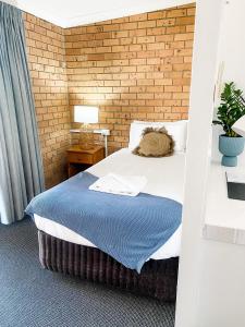 a bedroom with a bed and a window at Pacific Sun Bargara in Bargara