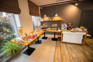 a kitchen with a table with food on it at Hotel Platan in Ostrów Wielkopolski