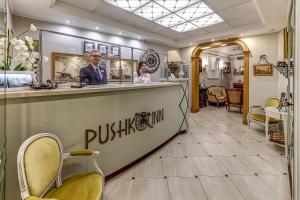 a man and woman standing at a bar in a store at Pushka INN hotel in Saint Petersburg