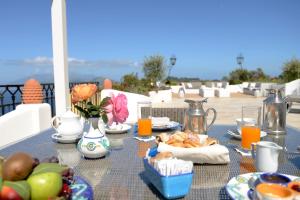 a table with food and drinks on top of a balcony at Hotel Caesar Augustus in Anacapri
