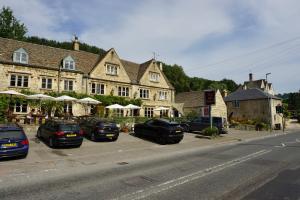 a group of cars parked in front of a building at The Coach House and The Stable in Woodchester