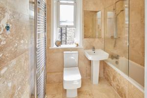 a bathroom with a toilet and a sink and a shower at Host & Stay - Kulla Loft in Harrogate