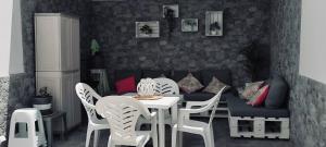 a room with a table and chairs and a couch at Apartamento Yale in Tías +6 photos