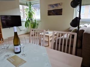 a bottle of wine sitting on a table with two glasses at Weingut Markus Busch in Pünderich