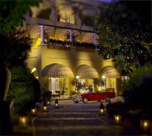 a red car parked in front of a building at Hotel Caesar Augustus in Anacapri
