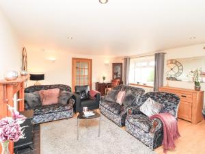 a living room with two couches and a fireplace at Solway Firth View in Annan