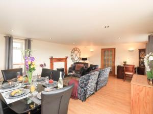 a dining room with a table and a living room at Solway Firth View in Annan