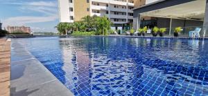 a large swimming pool on the side of a building at Dwharf Seaview Executive Suit PortDickson in Port Dickson