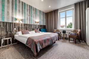Posteľ alebo postele v izbe v ubytovaní Royal Court Hotel