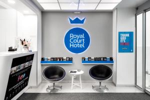 a room with two chairs and a royal court hotel at Royal Court Hotel in Prague