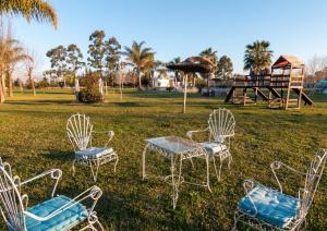 a group of chairs and a table and a playground at Complejo Paradise in Colón