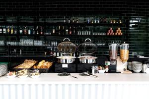 a counter with some food on a table at B&B HOTEL Basel in Basel