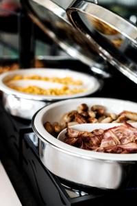 a bunch of food in pots on a stove at B&B HOTEL Basel in Basel