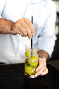 a man is holding a drink with a straw at B&B HOTEL Basel in Basel