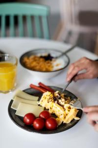a person eating food on a table with a plate of food at B&B HOTEL Basel in Basel