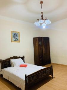 a bedroom with a bed and a chandelier at Infinity Hostel & Tour in Yerevan