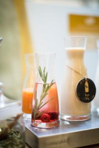 a table with two glasses and a vase with a drink at Petit Palace Plaza España in Madrid